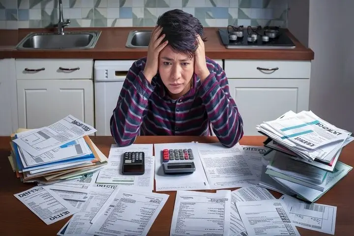 How do I pay off debt if I live paycheck to paycheck?